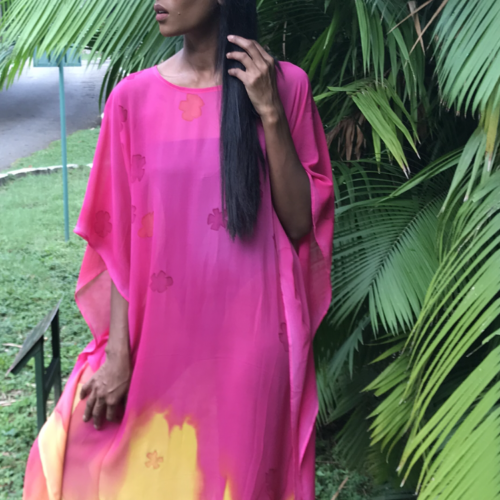 Striking Caribbean colors of raspberry and orangey yellow adorn this hand-dyed silk kaftan, forming a beautiful wave pattern at the hem. It's perfect for any occasion.