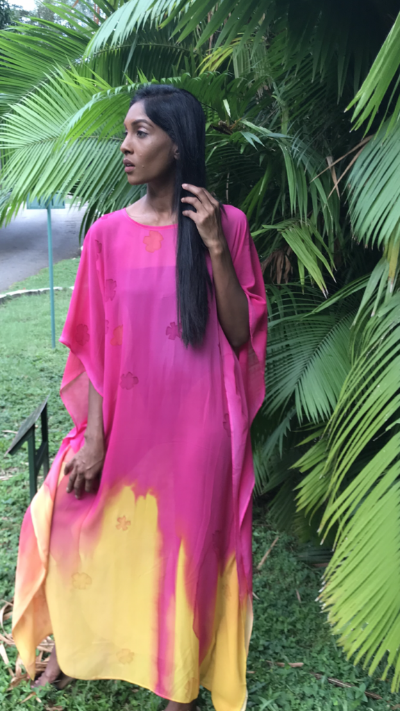 Striking Caribbean colors of raspberry and orangey yellow adorn this hand-dyed silk kaftan, forming a beautiful wave pattern at the hem. It's perfect for any occasion.